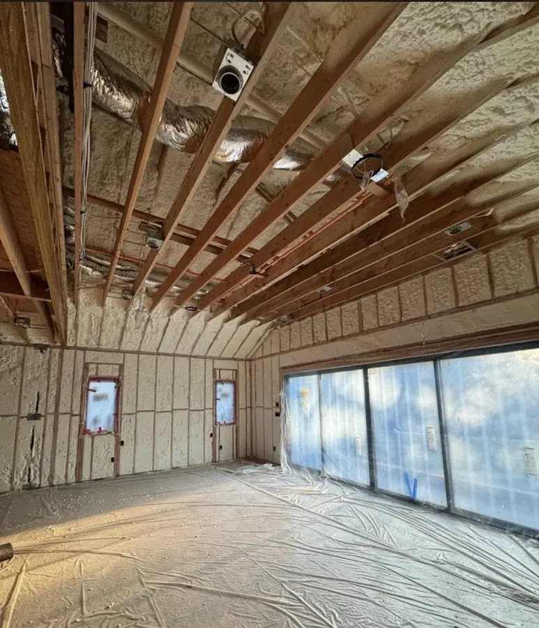 Interior walls and ceiling insulated with spray foam during new construction in Central Falls